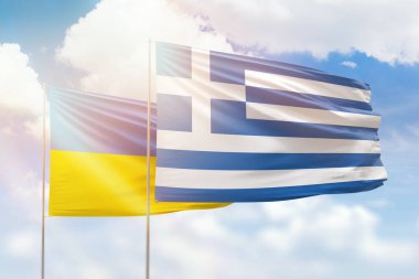 Sunny blue sky and flags of greece and ukraine