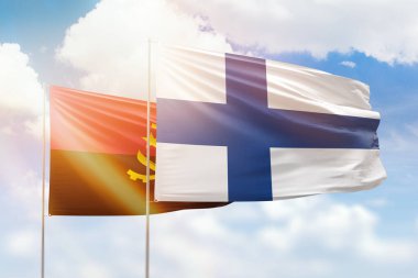 Sunny blue sky and flags of finland and angola