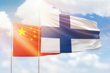 Sunny blue sky and flags of finland and china