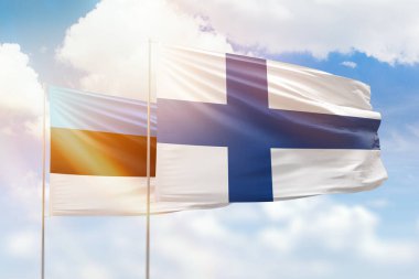 Sunny blue sky and flags of finland and estonia