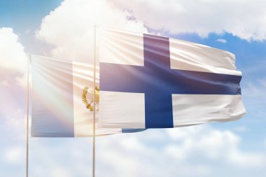 Sunny blue sky and flags of finland and guatemala