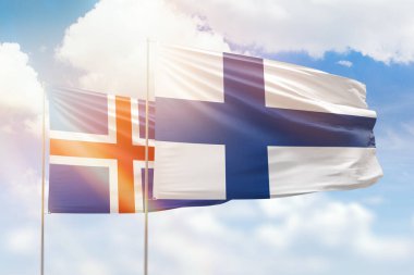 Sunny blue sky and flags of finland and iceland