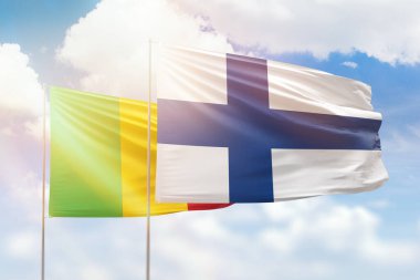 Sunny blue sky and flags of finland and mali