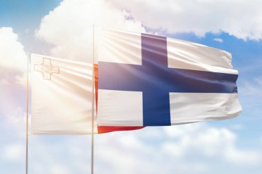 Sunny blue sky and flags of finland and malta