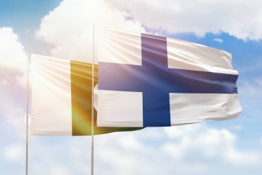Sunny blue sky and flags of finland and pakistan
