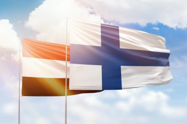 Sunny blue sky and flags of finland and yemen