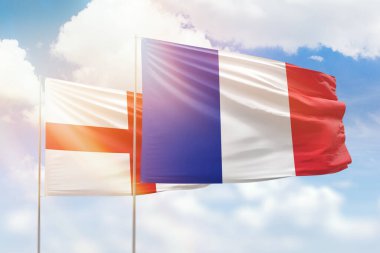 Sunny blue sky and flags of france and england