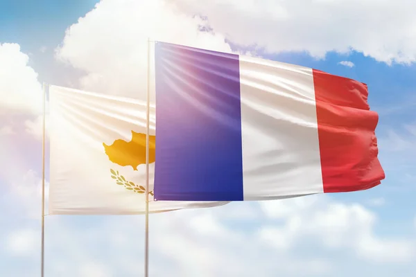 Sunny blue sky and flags of france and cyprus