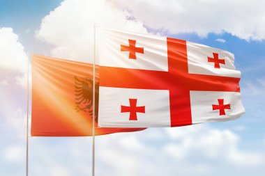 Sunny blue sky and flags of georgia and albania