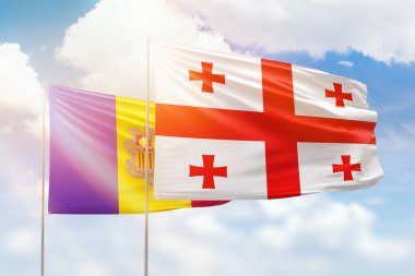 Sunny blue sky and flags of georgia and andorra