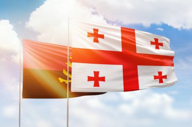 Sunny blue sky and flags of georgia and angola
