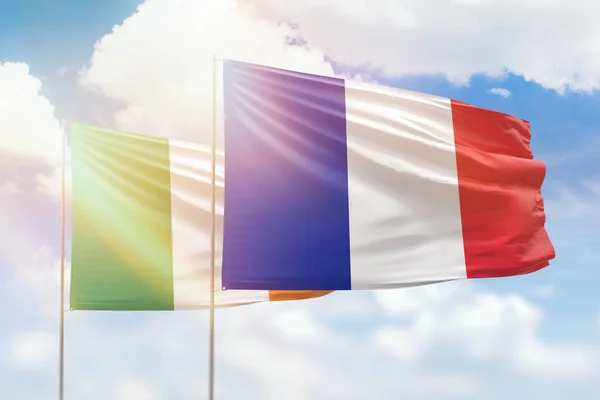 Sunny blue sky and flags of france and ireland