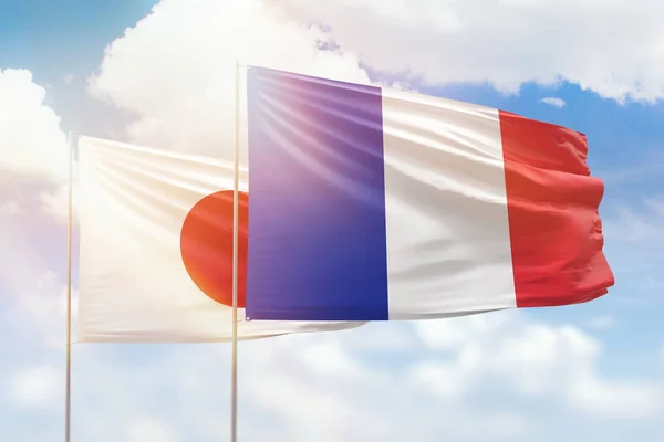 Sunny blue sky and flags of france and japan