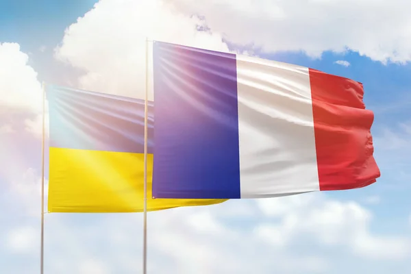 Sunny blue sky and flags of france and ukraine