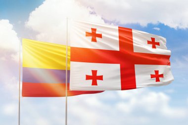Sunny blue sky and flags of georgia and colombia