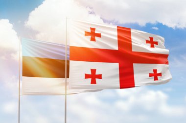 Sunny blue sky and flags of georgia and estonia