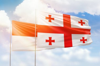 Sunny blue sky and flags of georgia and indonesia