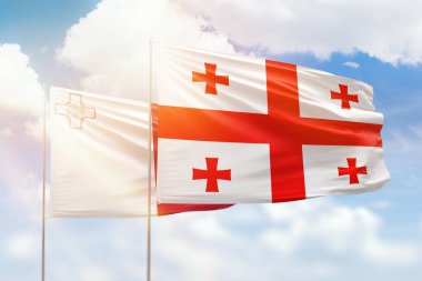Sunny blue sky and flags of georgia and malta