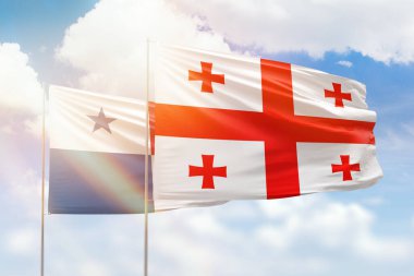 Sunny blue sky and flags of georgia and panama