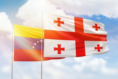 Sunny blue sky and flags of georgia and venezuela