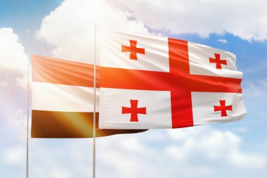 Sunny blue sky and flags of georgia and yemen