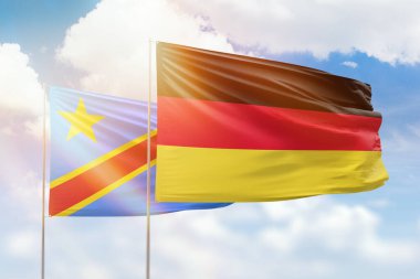 Sunny blue sky and flags of germany and dr congo