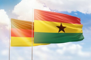 Sunny blue sky and flags of ghana and germany