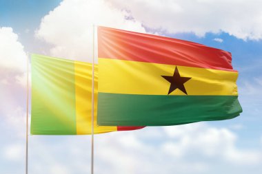 Sunny blue sky and flags of ghana and mali