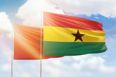 Sunny blue sky and flags of ghana and morocco