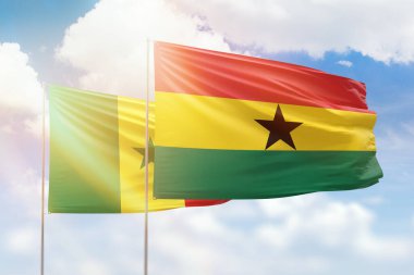 Sunny blue sky and flags of ghana and senegal