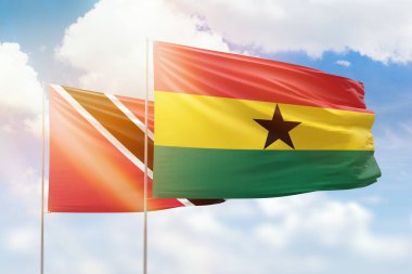 Sunny blue sky and flags of ghana and trinidad and tobago