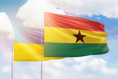 Sunny blue sky and flags of ghana and ukraine
