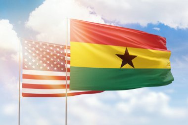 Sunny blue sky and flags of ghana and usa