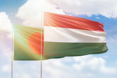 Sunny blue sky and flags of hungary and bangladesh