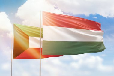 Sunny blue sky and flags of hungary and kuwait