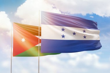 Sunny blue sky and flags of honduras and jordan