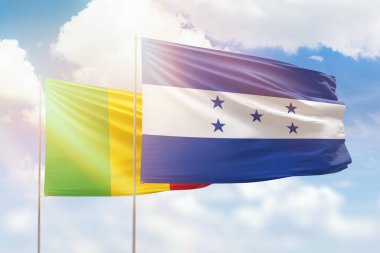 Sunny blue sky and flags of honduras and mali