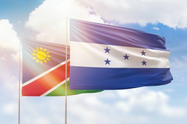 Sunny blue sky and flags of honduras and namibia