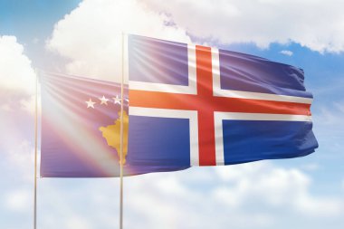 Sunny blue sky and flags of iceland and kosovo