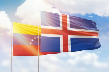 Sunny blue sky and flags of iceland and venezuela