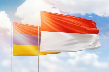 Sunny blue sky and flags of indonesia and armenia