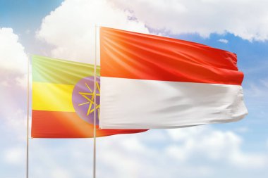 Sunny blue sky and flags of indonesia and ethiopia