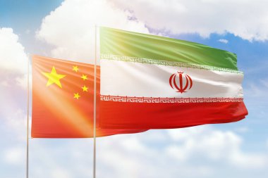 Sunny blue sky and flags of iran and china