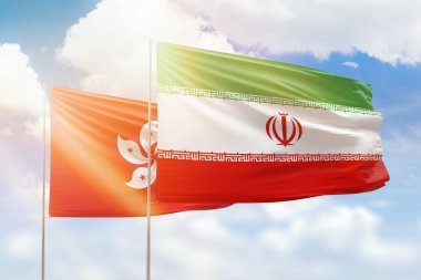 Sunny blue sky and flags of iran and hong kong