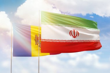Sunny blue sky and flags of iran and moldova