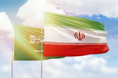 Sunny blue sky and flags of iran and saudi arabia