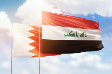 Sunny blue sky and flags of iraq and bahrain