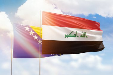 Sunny blue sky and flags of iraq and bosnia