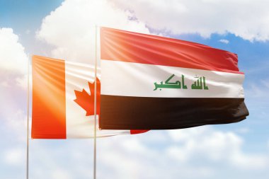 Sunny blue sky and flags of iraq and canada