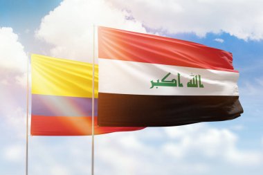 Sunny blue sky and flags of iraq and colombia